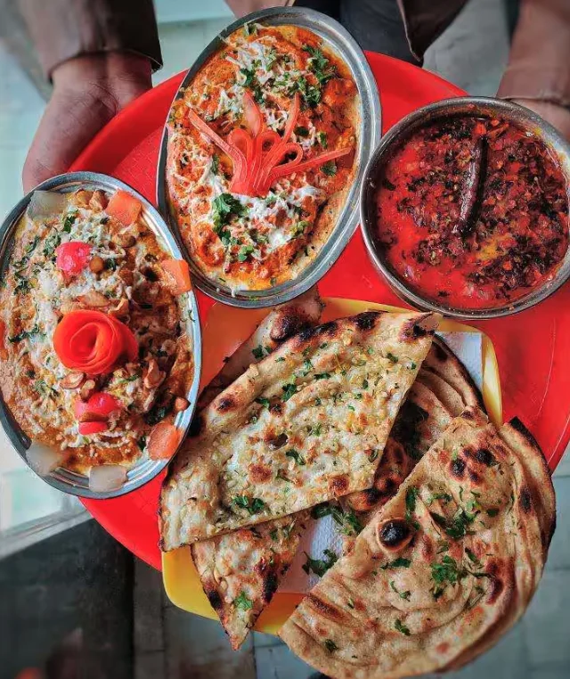 Paneer curries with garlic naan and lachha parantha at Chotiwala